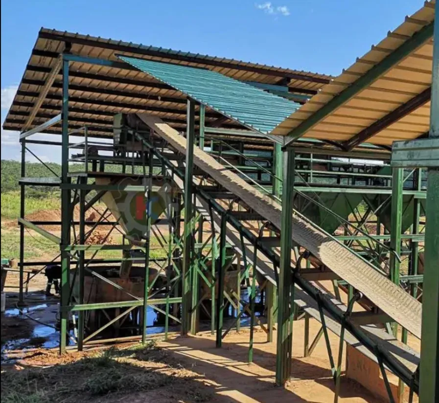 Green steel conveyor structure beneath a new shed roof at Filabusi