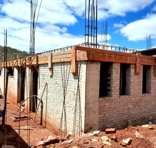 Blockwork walls of a new building rising, with column reinforcement in place