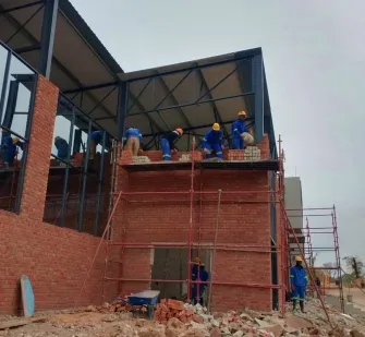 Builders working on the facade from scaffolding