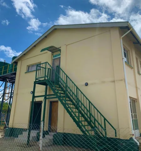 Completed two-storey hostel with a green external staircase